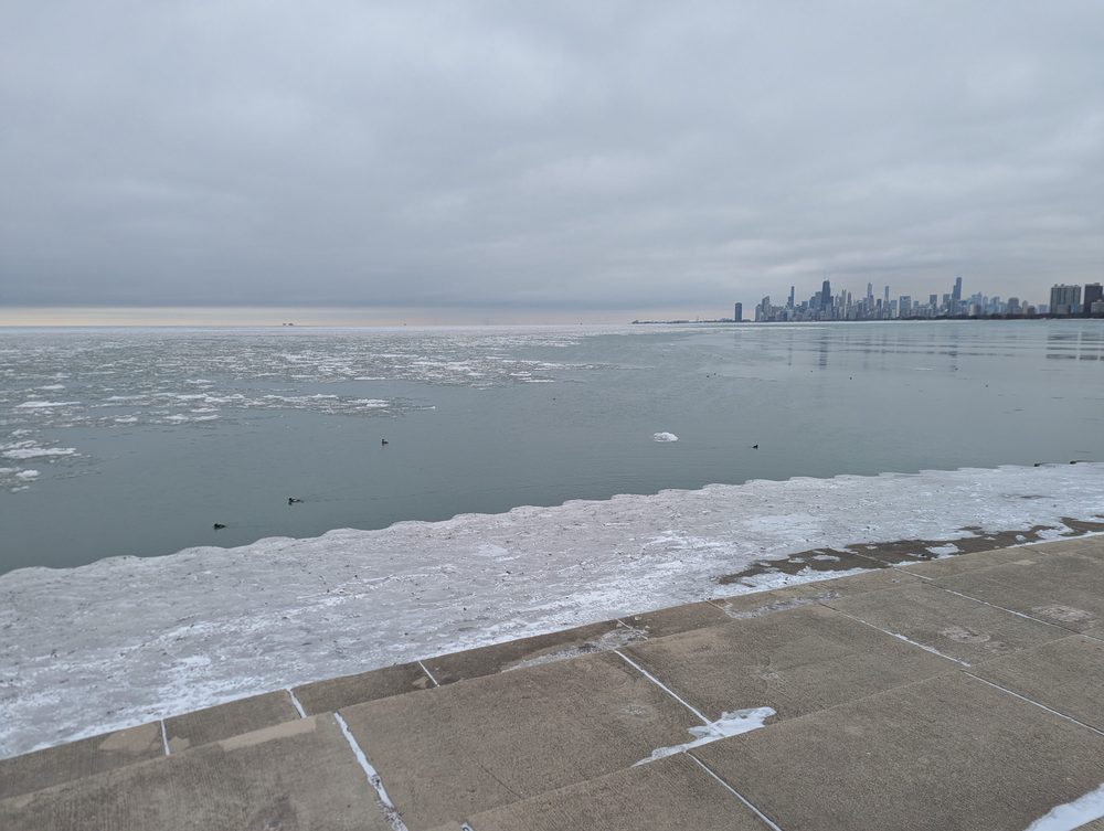 Ice along the Lake Michigan shore with the skyline in the distance